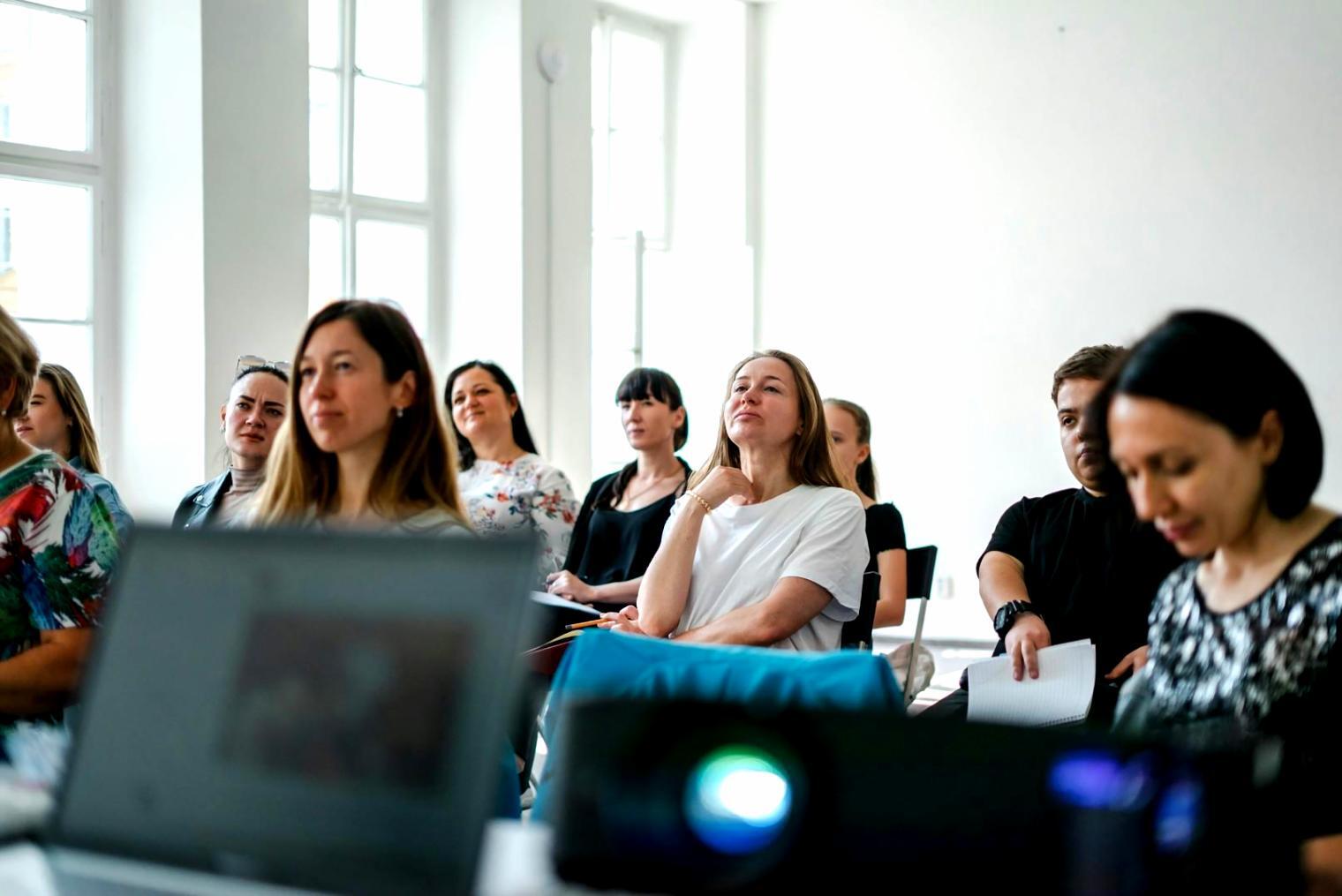 Participants reviewing financial planning materials during interactive workshop session
